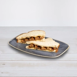 A Quorn sausage butty cut into halves and served on a plate at Hungry Horse venues.