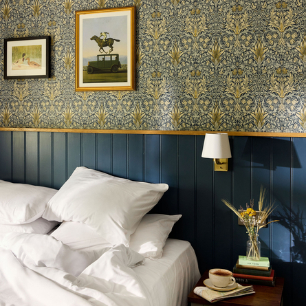 Hotel bedroom with artwork and decorated bedside table