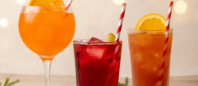 An advertising image of the Santa On The Beach, Cherry Cheer and Merry Spritzmas cocktails available at Farmhouse Inns.