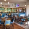 The bar and interior restaurant seating area at The Kittoch, with a TV on the wall.