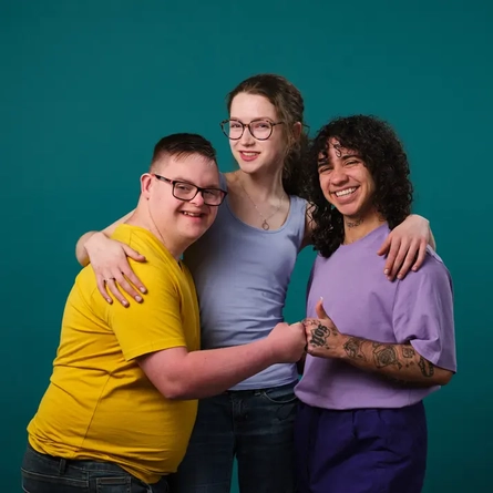 Three friends hugging each other