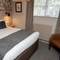 The interior hotel double bedroom with a king bed at the Cedars Inn