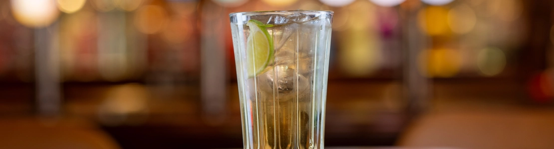 A glass of Elderflower Mojito on a wooden table of a pub