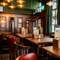 An interior restaurant seating area at the King's Head, with green velvet curtains; dark wood panelled walls; and upholstered chairs.