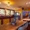 The bar and interior restaurant seating area at the Counting House, with TVs on the walls.