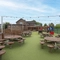 Exterior play area and beer garden of a pub with a seating area.