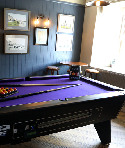 Interior of a pub with a pool table.