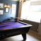 Interior of a pub with a pool table.