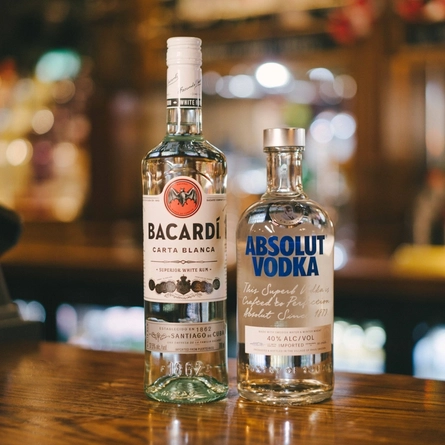A of Absolute vodka and Bacardi rum sat on the bar at a Greene King venue.