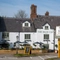 The exterior facade, signage, and seating area of The Blue Cap in Sandiway.