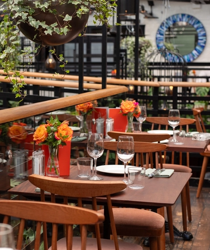 The upper level restaurant seating area with hanging plants at The Ubiquitous Chip.