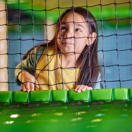 A child playing in an indoor play area.