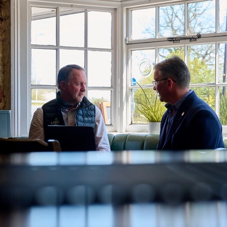 A Pub Partners image showing 2 people sat at a table within the Shinfield Arms.