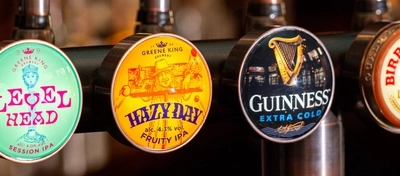 A close up view of beer taps for Level Head IPA, Hazy Day IPA, Guinness, Birra Moretti and Estrella Galicia, on the bar inside The Fountains Abbey.