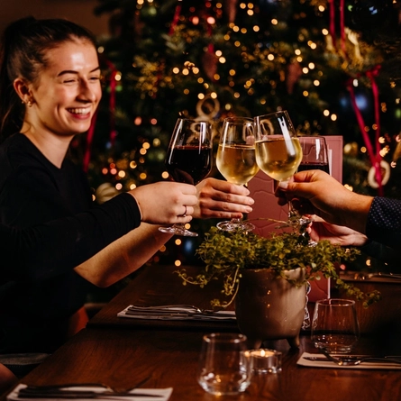 a group of people sitting at a table drinking wine