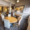 Interior dining area of a pub with a bar and a TV.