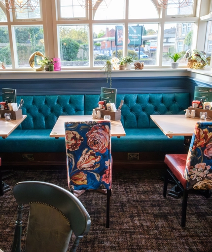 A close up view of one of the booth window seating areas inside The Talbot Inn, with ornaments sitting on the window sill.