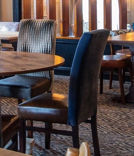 The interior restaurant and seating area with TV at the Poachers 