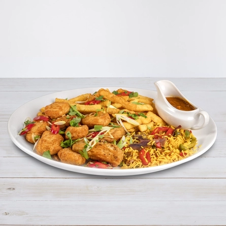 The Non-Gluten Containing Ingredients Banging Katsu Banquet meal at Hungry Horse venues, featuring chicken pieces served on a plate with chips, rice and a jug of Katsu curry sauce.