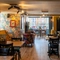 The interior restaurant seating area at The Windmill Inn, with wooden flooring and a fireplace.