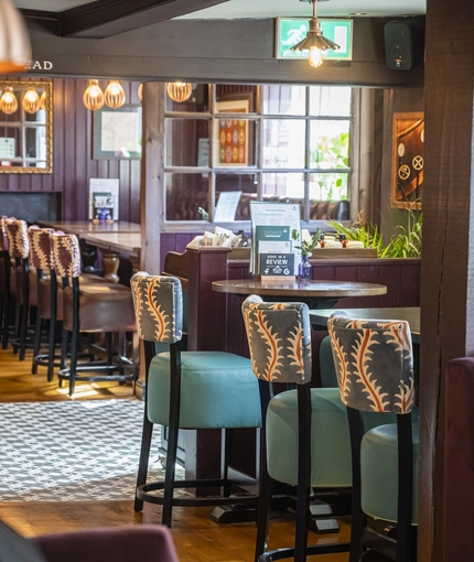 The interior restaurant and seating area with log burner at The Bell.