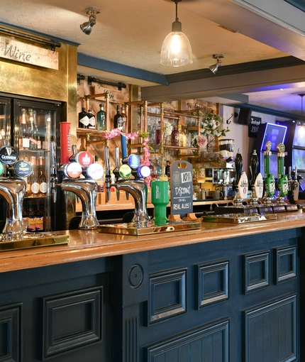 Interior bar area of a pub with a few gambling machines.