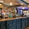 Interior bar area of a pub with a few gambling machines.