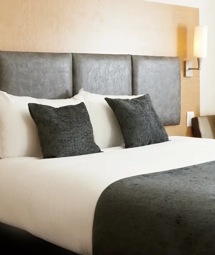 The interior of one of the hotels room featuring a double and 2 single beds at The Quays.