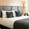 The interior of one of the hotels room featuring a double and 2 single beds at The Quays.