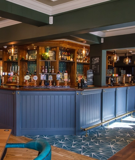 The interior bar and restaurant seating area with dartboard at The Hare & Hounds.