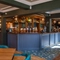 The interior bar and restaurant seating area with dartboard at The Hare & Hounds.