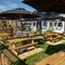 The exterior beer garden seating area with wooden picnic tables and shade umbrellas, at The Man On The Moon in Ipswich.