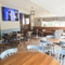 Interior dining area of a pub with a TV.