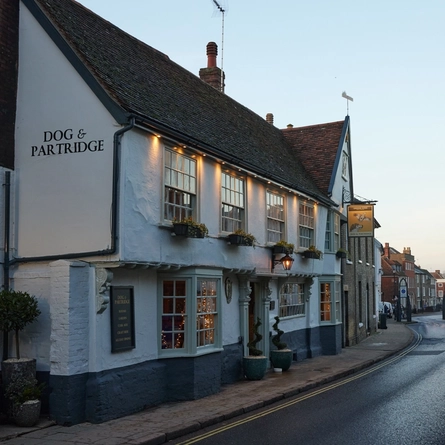 A side view of the exterior looking down the street at The Dog and Partridge.