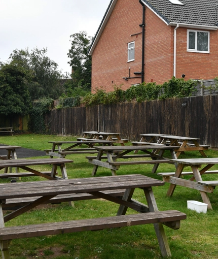 exterior beer garden of a pub with a play area and a seating area