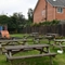 exterior beer garden of a pub with a play area and a seating area