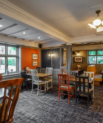 Interior dining area of a pub with a TV.