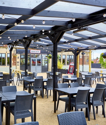 The exterior undercover beer garden seating area at The Fox and Crown.
