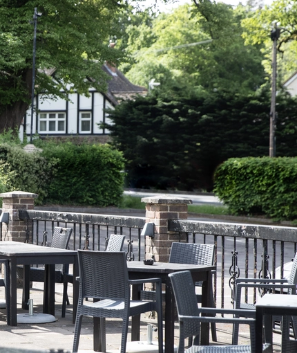 Exterior beer garden of a pub with a seating area.