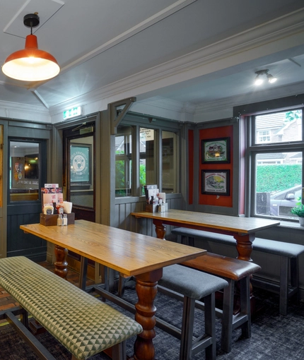 Interior dining area of a pub with a bar.