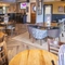 Interior dining area of a pub with a bar and a TV.