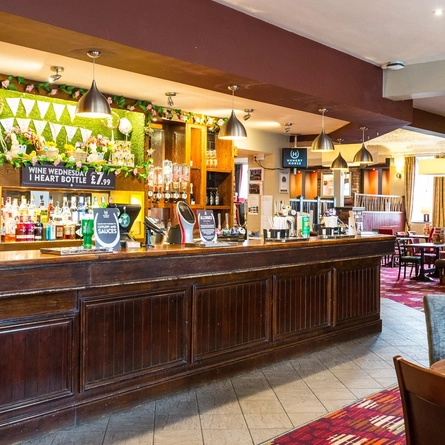 Interior dining area of a pub with a bar.