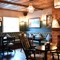 Interior dining area of a pub with a fireplace.