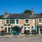 The exterior facade and beer garden seating area at The Hare & Hounds.