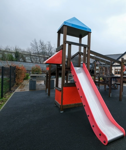 exterior beer garden of a pub with a play area and a seating area