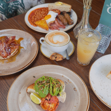 A banner showing a close up image of breakfast dishes sat on a table to advertise a Breakfast With Santa event at Chef & Brewer.