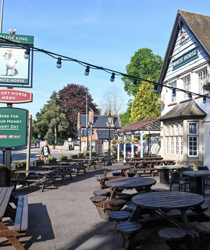 Exterior beer garden of a pub with a dining area.