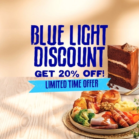 A banner featuring the words "Blue Light Discount, Get 20% Off! Limited Time Offer", on an image of a plate of roast dinner and a plate of chocolate cake, sitting on a wooden table.