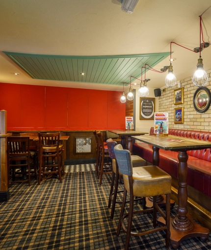 Interior dining area of a pub with a TV.