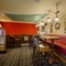 Interior dining area of a pub with a TV.